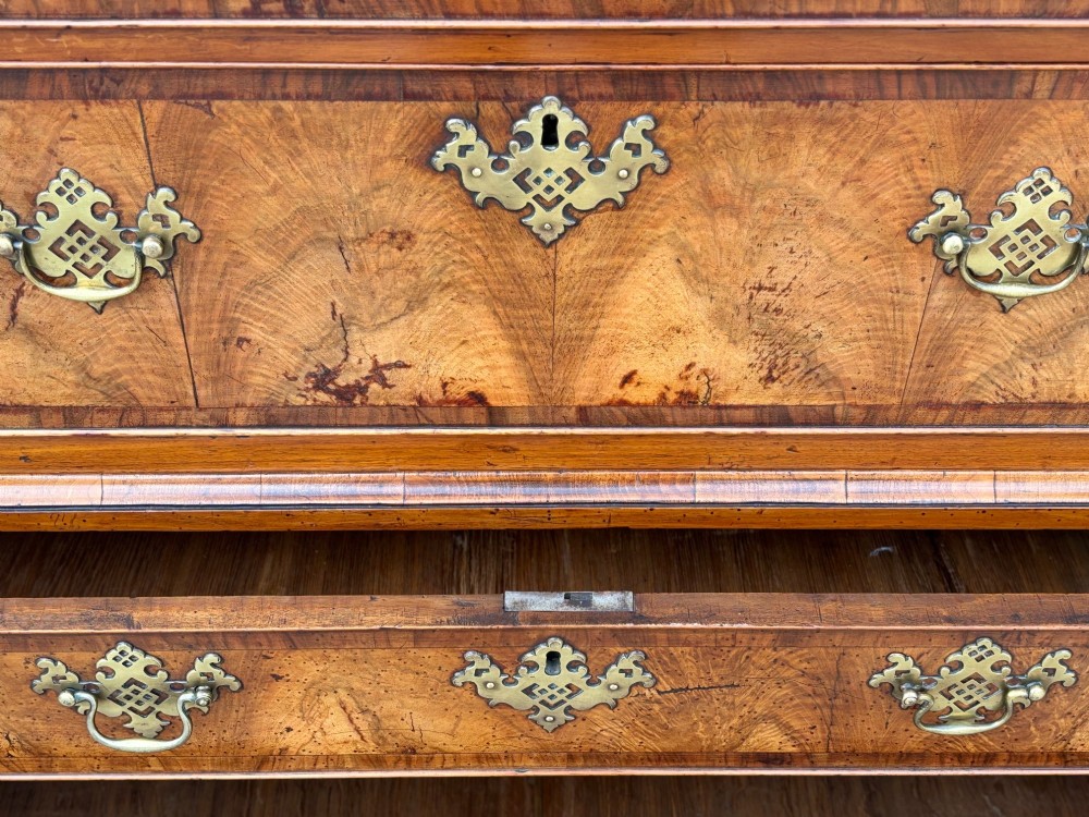 An eighteenth-century George II walnut chest on chest featuring two short over six long graduated drawers with decorative brass handles, keyhole escutcheons, and bracket feet. View IV