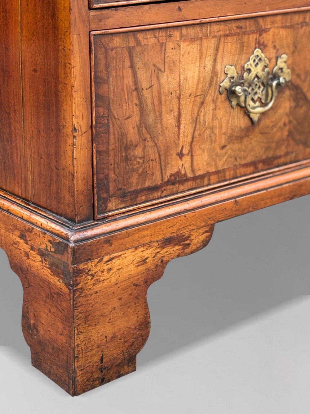 An eighteenth-century George II walnut chest on chest featuring two short over six long graduated drawers with decorative brass handles, keyhole escutcheons, and bracket feet. View VIII