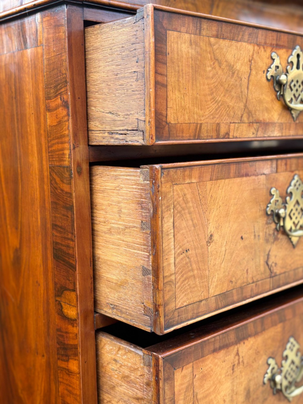 An eighteenth-century George II walnut chest on chest featuring two short over six long graduated drawers with decorative brass handles, keyhole escutcheons, and bracket feet. View IX