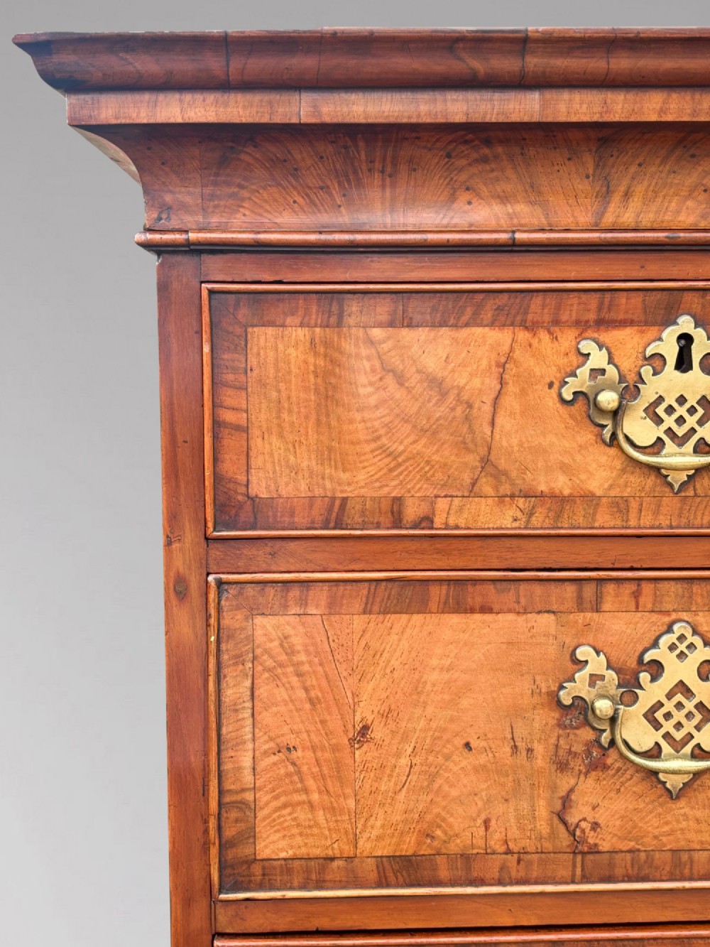 An eighteenth-century George II walnut chest on chest featuring two short over six long graduated drawers with decorative brass handles, keyhole escutcheons, and bracket feet. View XI