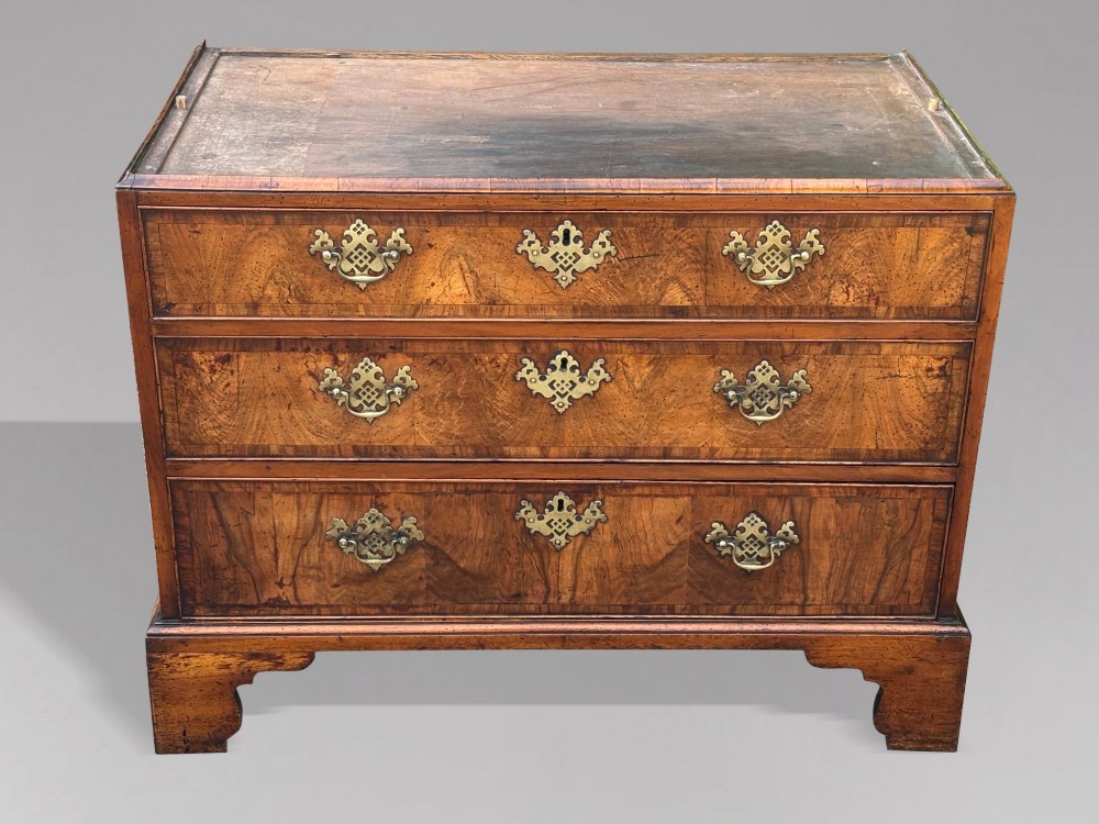 An eighteenth-century George II walnut chest on chest featuring two short over six long graduated drawers with decorative brass handles, keyhole escutcheons, and bracket feet. View XIII