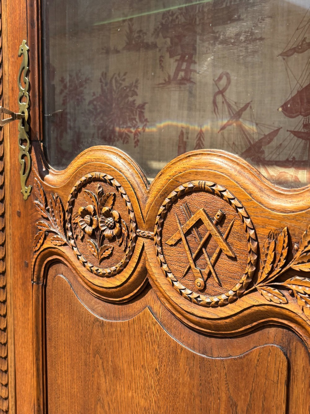 An 18th-century carved oak French buffet deux corps featuring upper glazed doors lined with fabric above a panelled lower cabinet with relief carvings. View VII