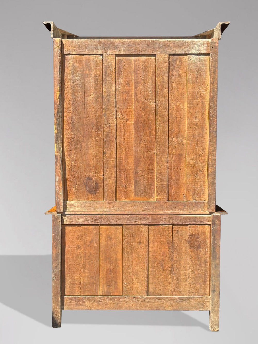 An 18th-century carved oak French buffet deux corps featuring upper glazed doors lined with fabric above a panelled lower cabinet with relief carvings. View VIII