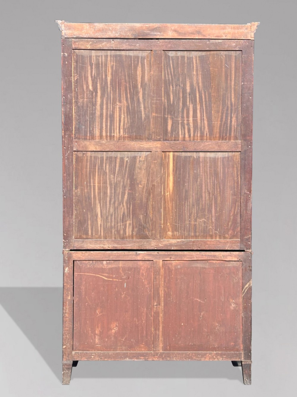 An eighteenth-century George III tall mahogany bookcase featuring two upper astragal glazed doors, lower flame-veneered cabinet doors, and a moulded cornice. View VIII