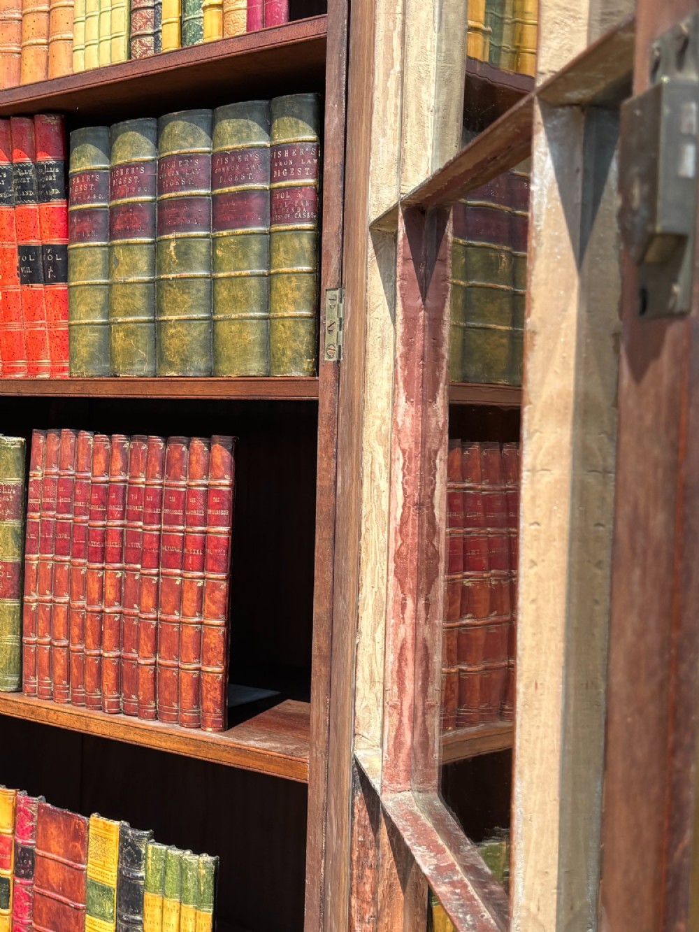 An eighteenth-century George III tall mahogany bookcase featuring two upper astragal glazed doors, lower flame-veneered cabinet doors, and a moulded cornice. View XI