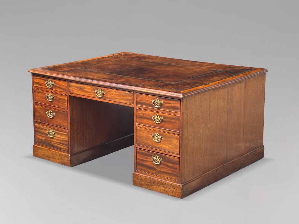 An 18th-century George III mahogany partners desk featuring an inset leather writing surface, brass swan-neck handles, and twin pedestals with stacked drawers. View VIII