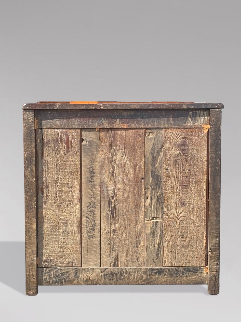 A 17th-century French Provincial walnut commode featuring three long drawers decorated with brass drop handles and central escutcheons. View V