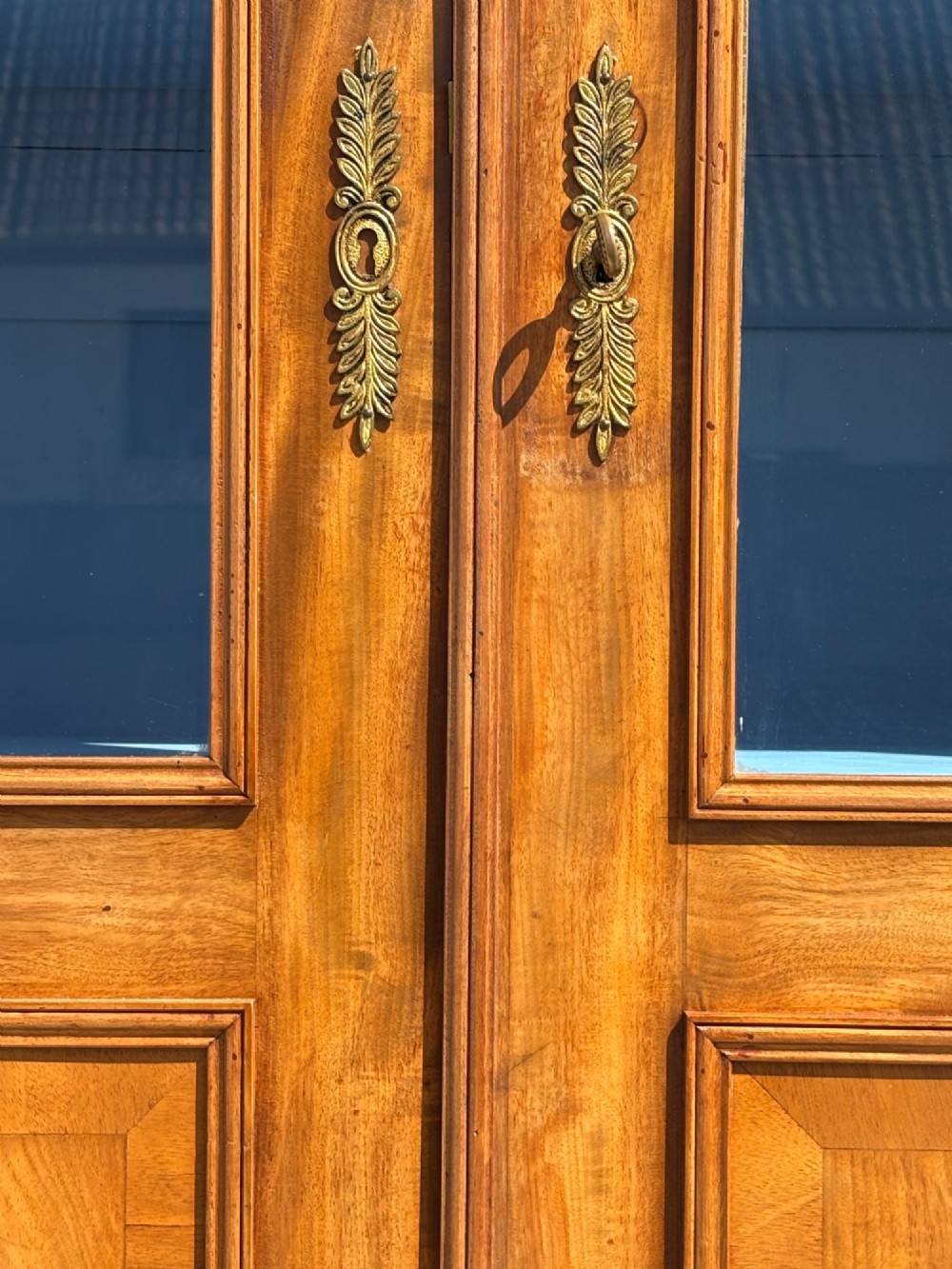 A 19th-century French Louis Philippe walnut four-door bookcase featuring glazed upper doors, panelled lower sections, and a blue painted interior. View VI