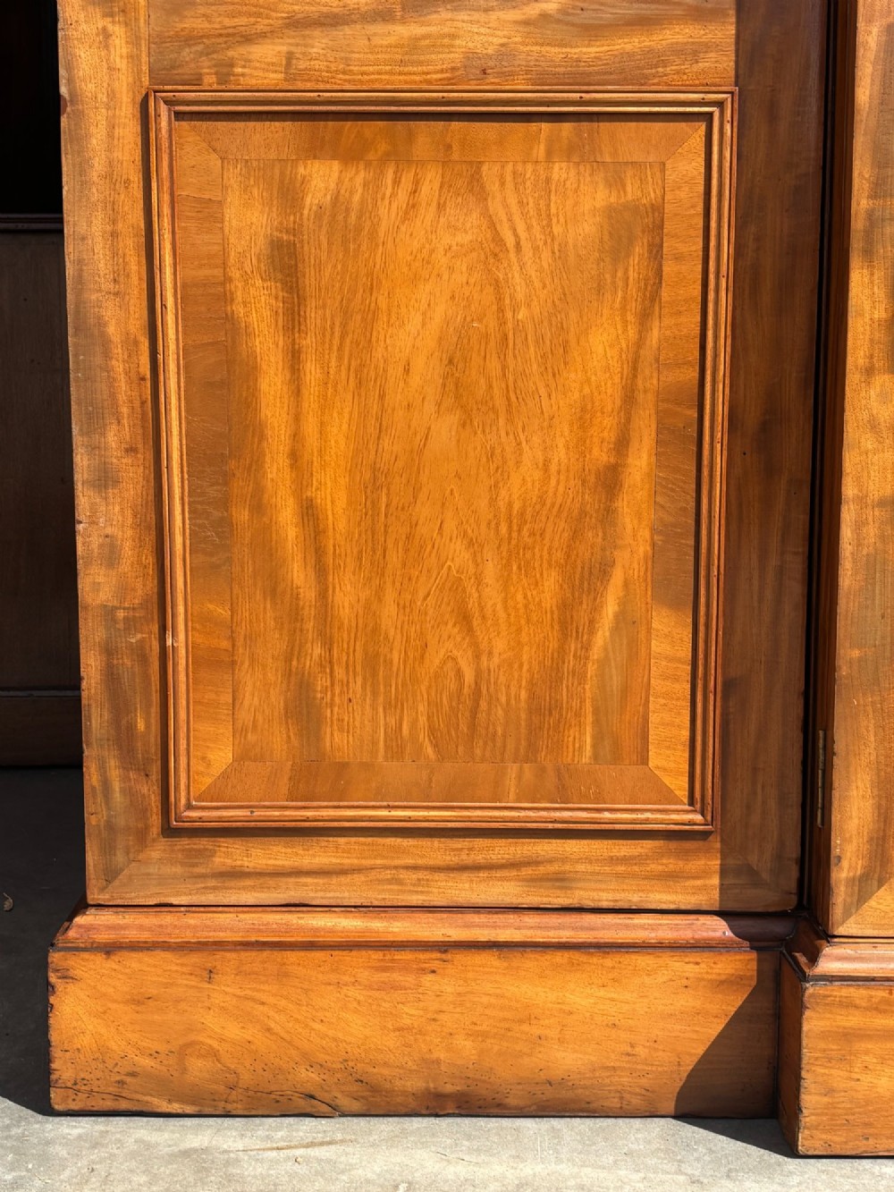 A 19th-century French Louis Philippe walnut four-door bookcase featuring glazed upper doors, panelled lower sections, and a blue painted interior. View VII