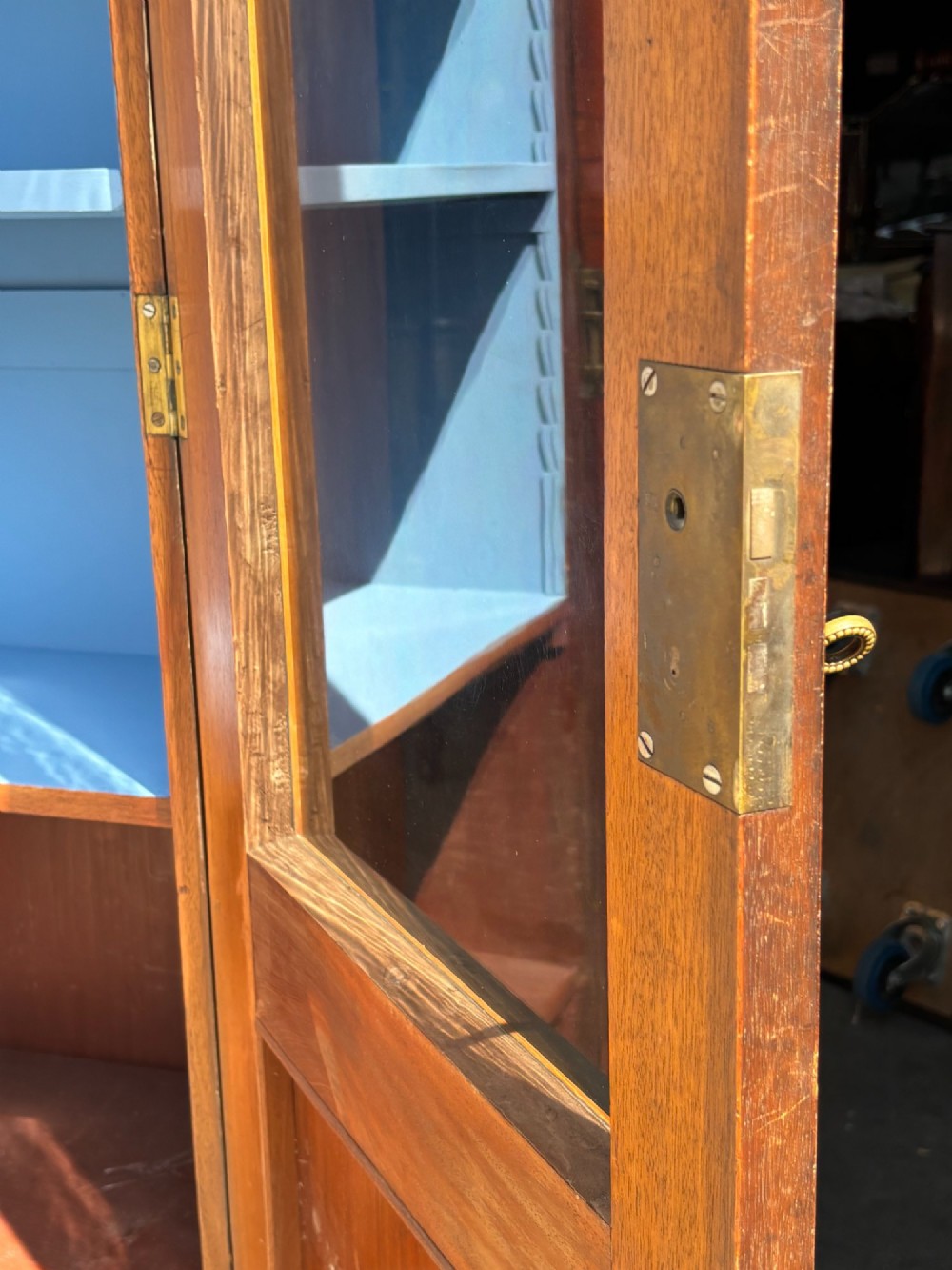 A 19th-century French Louis Philippe walnut four-door bookcase featuring glazed upper doors, panelled lower sections, and a blue painted interior. View VIII