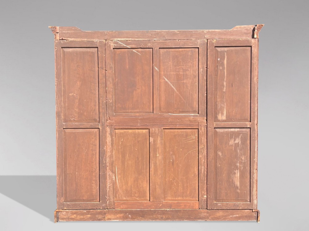 A 19th-century French Louis Philippe walnut four-door bookcase featuring glazed upper doors, panelled lower sections, and a blue painted interior. View X