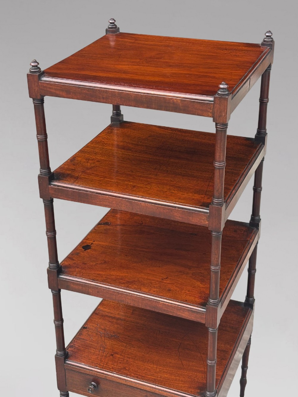 A four-tier George III mahogany whatnot features turned corner columns topped with small finials and includes a single drawer built into the lowest shelf. View III