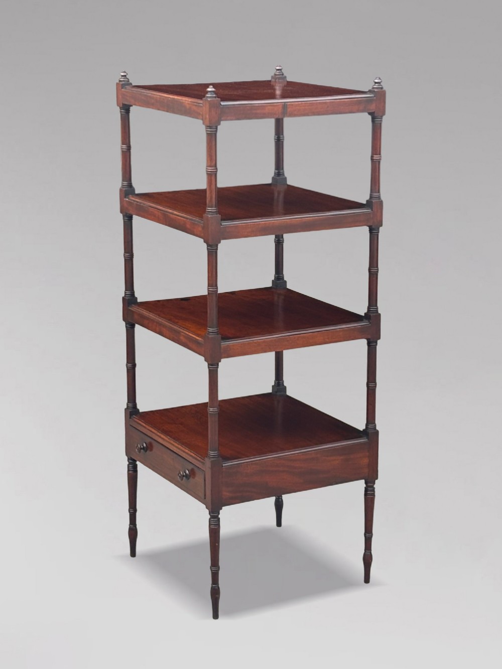 A four-tier George III mahogany whatnot features turned corner columns topped with small finials and includes a single drawer built into the lowest shelf. View X