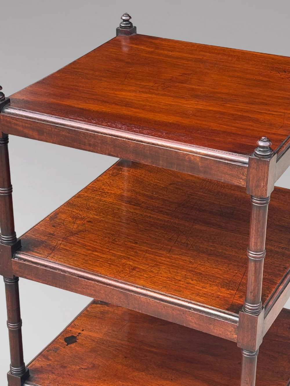 A four-tier George III mahogany whatnot features turned corner columns topped with small finials and includes a single drawer built into the lowest shelf. View XI