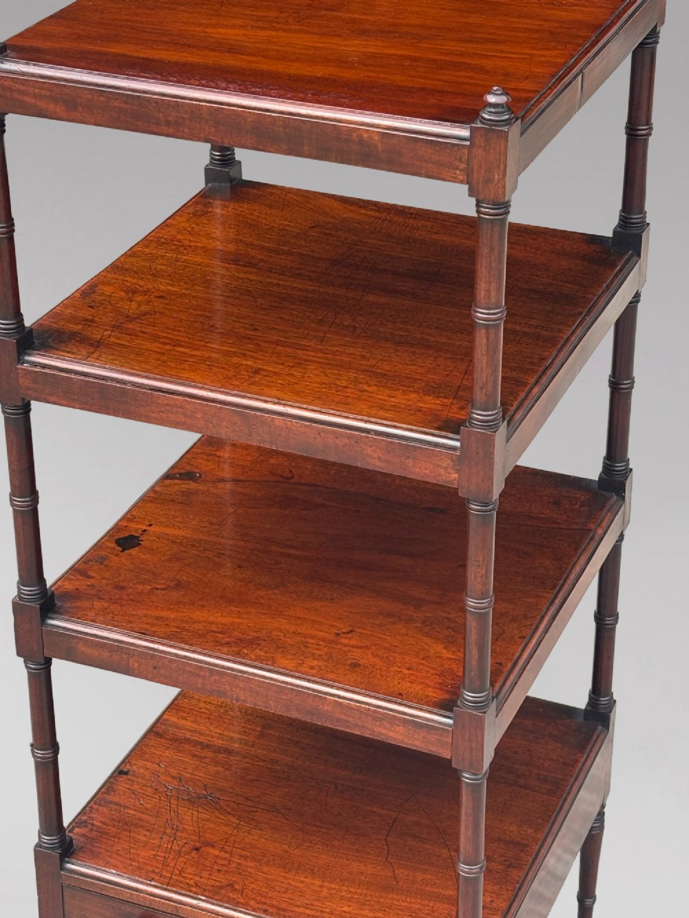 A four-tier George III mahogany whatnot features turned corner columns topped with small finials and includes a single drawer built into the lowest shelf. View XII