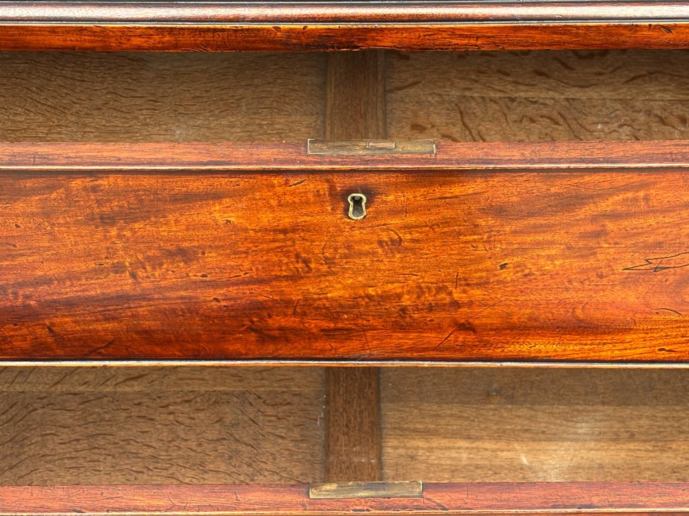 An 18th-century George III mahogany chest on chest featuring upper and lower drawer sections with brass handles and bracket feet. View IX