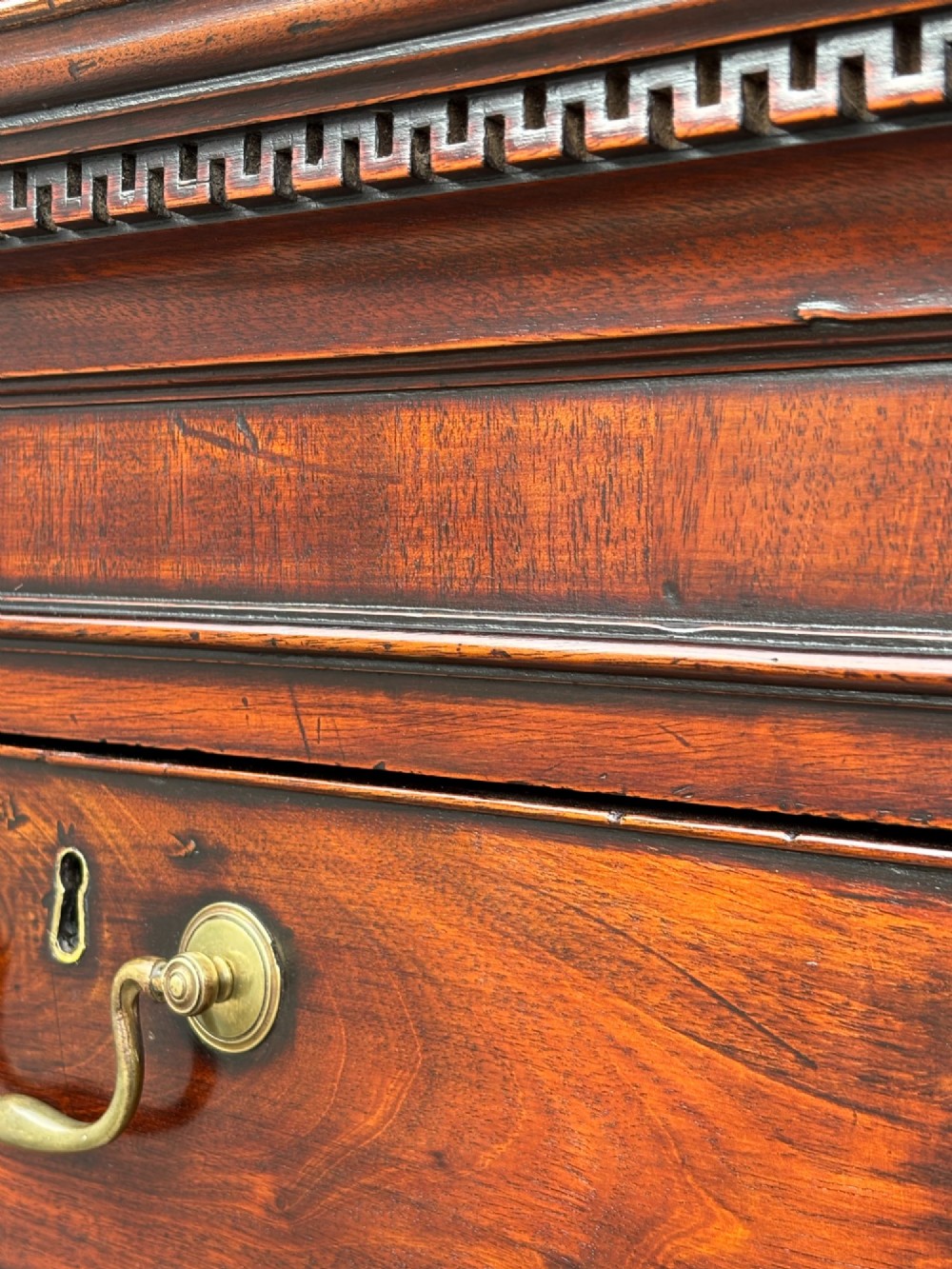 An 18th-century George III mahogany chest on chest featuring upper and lower drawer sections with brass handles and bracket feet. View X