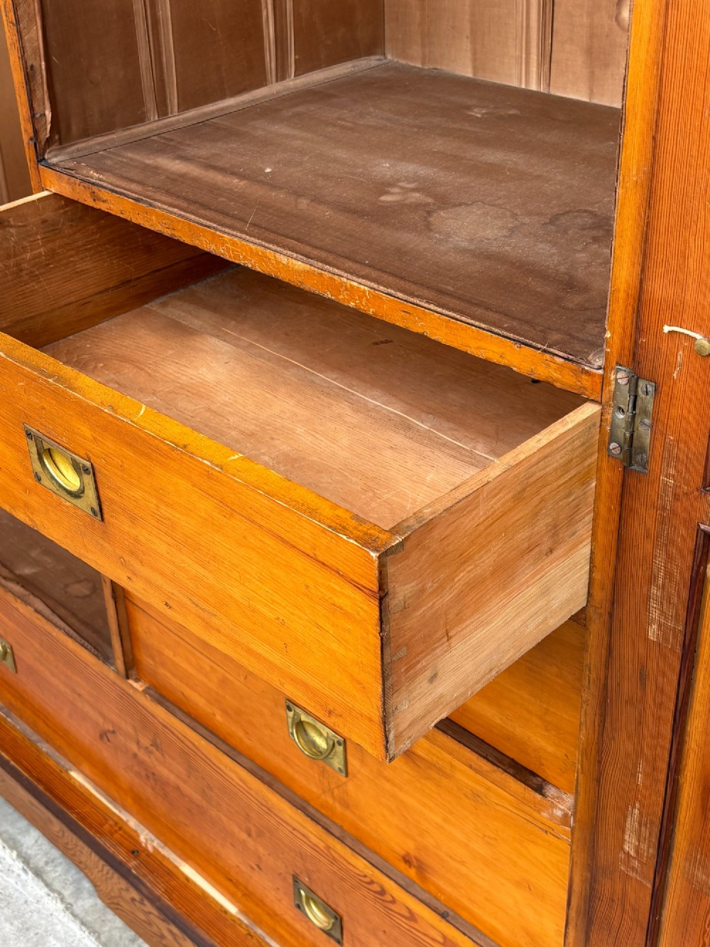 A late 19th-century pitch pine Arts and Crafts wardrobe featuring vertical slatted upper door panels, chevron lower panels, and a carved cresting rail. View XIII