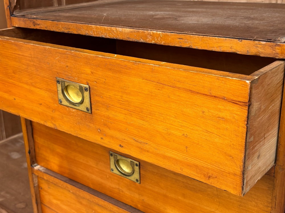 A late 19th-century pitch pine Arts and Crafts wardrobe featuring vertical slatted upper door panels, chevron lower panels, and a carved cresting rail. View XIV