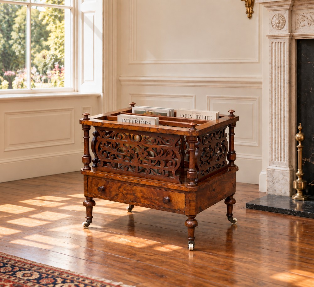 A mid-19th-century Victorian walnut music canterbury featuring open fretwork dividers, turned corner columns, a single base drawer, and turned legs with ceramic castors. View II