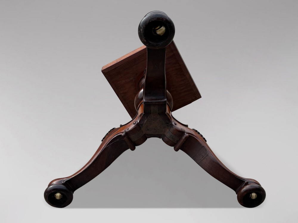 A circular William IV period rosewood centre table with a figured top on a carved pedestal and tripod base. View VIII