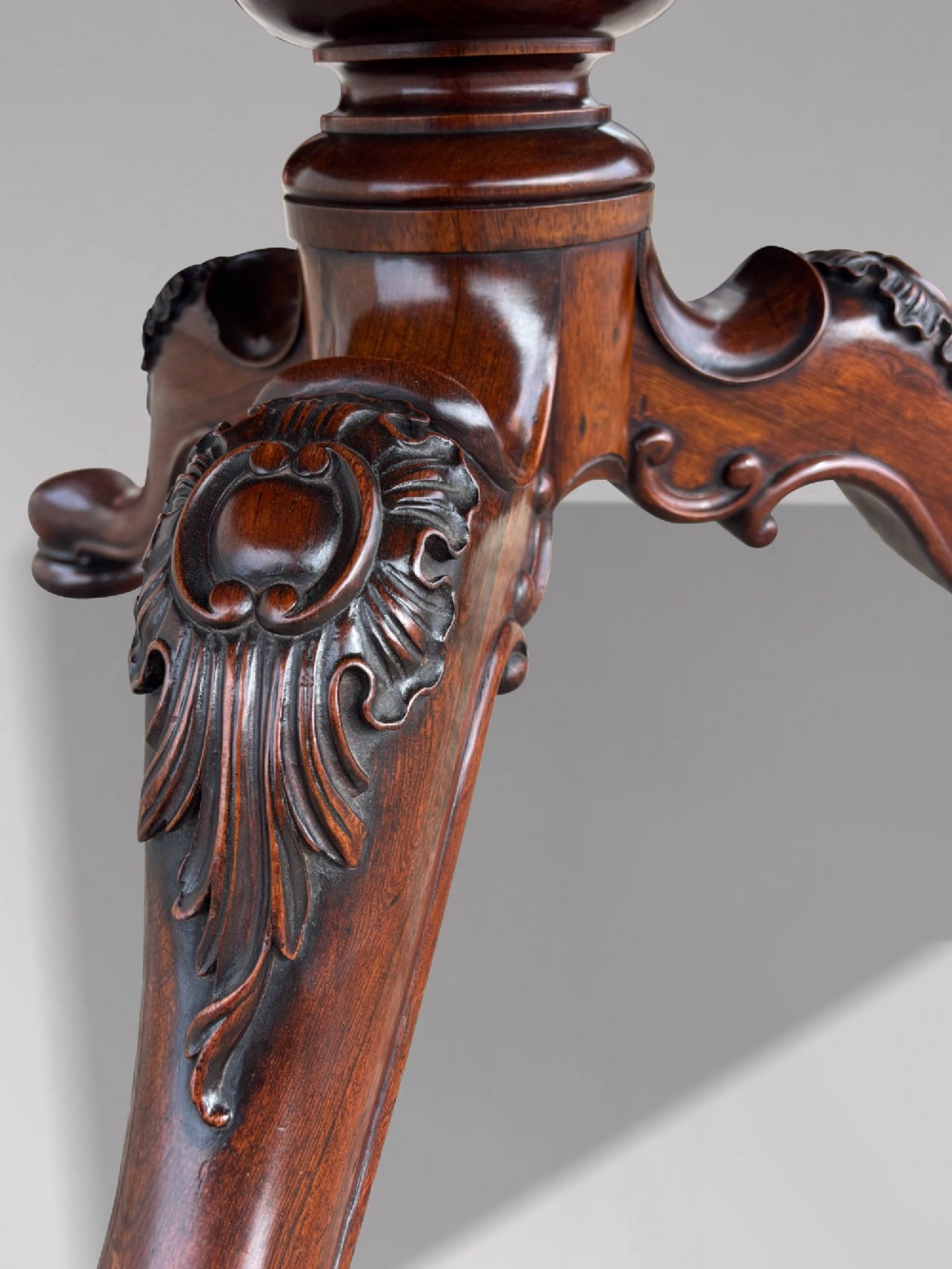 A circular William IV period rosewood centre table with a figured top on a carved pedestal and tripod base. View XI