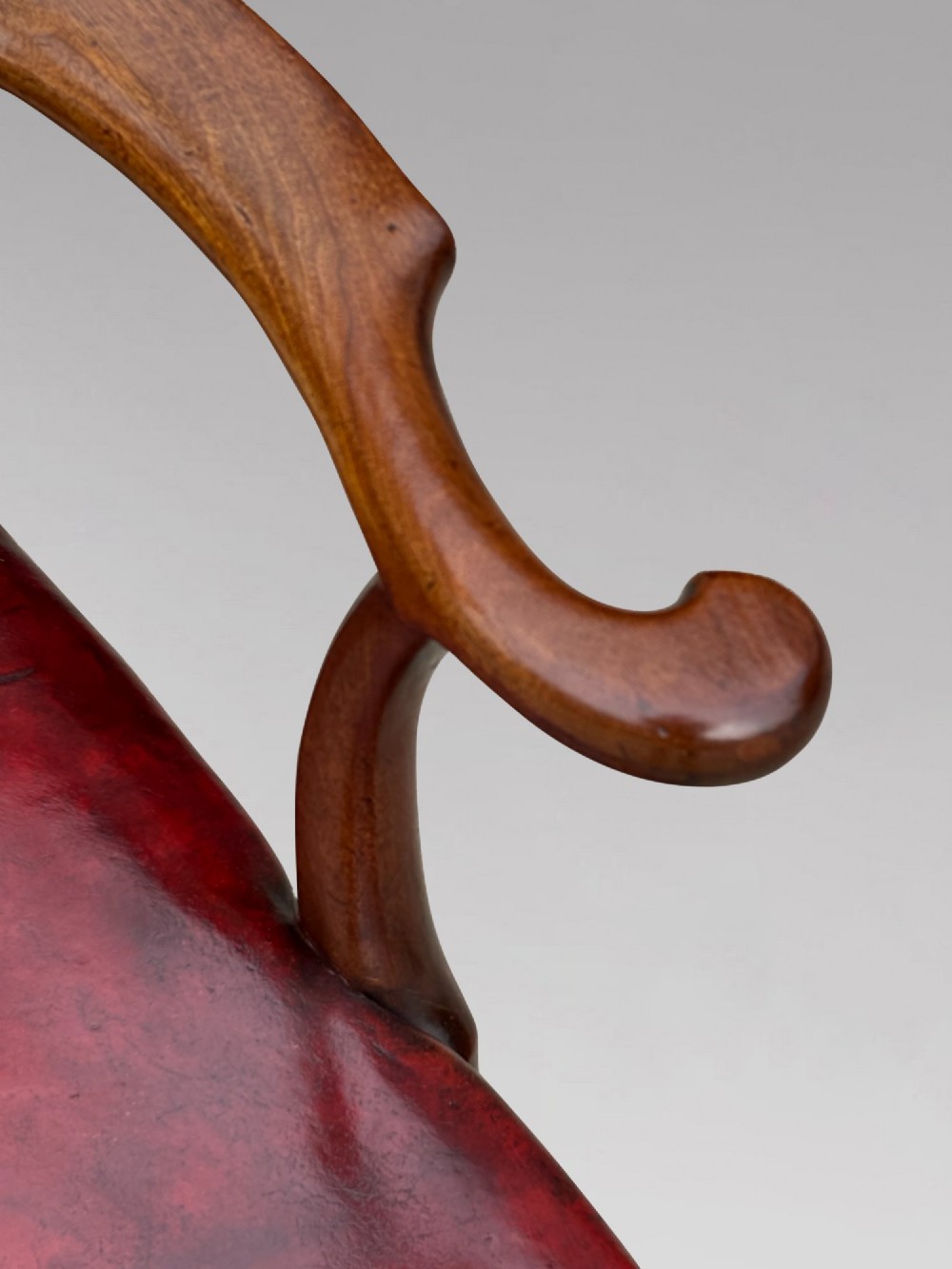 An 18th-century George III mahogany Chippendale armchair featuring a carved pierced splat back, curved arms, and a red leather upholstered seat. View VIII