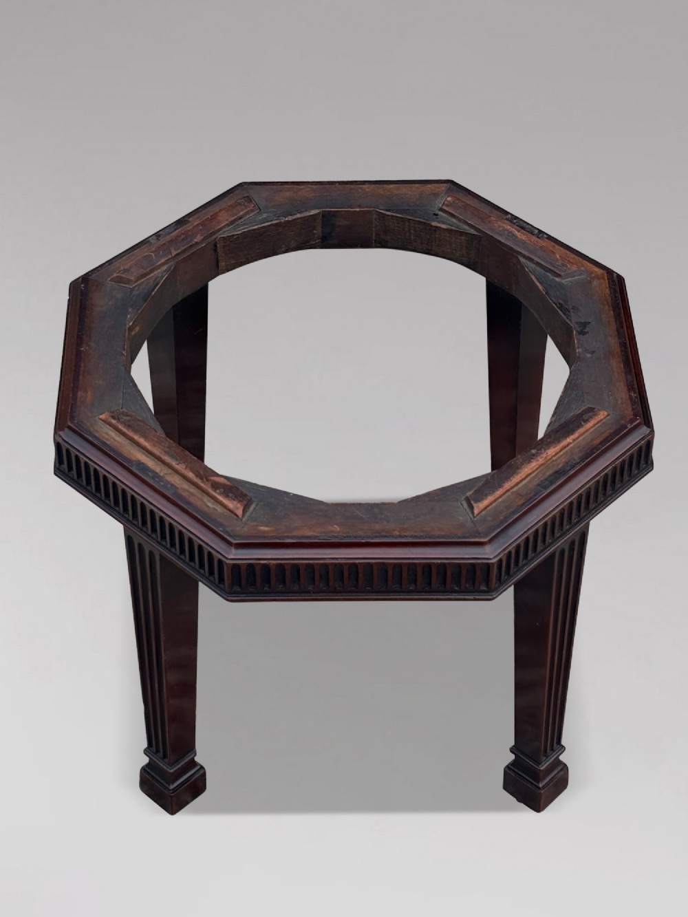 An eighteenth-century octagonal mahogany wine cooler featuring brass side handles, a keyhole detail, boxwood inlay, and fluted legs on castors. View VIII