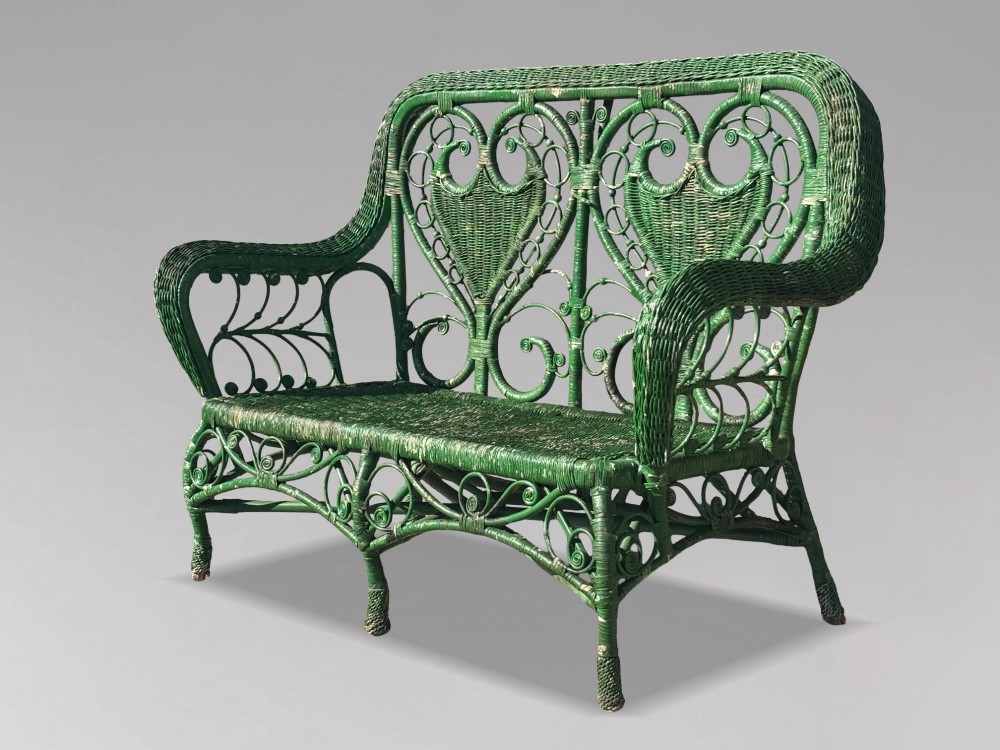 A French green painted wicker bench featuring two heart-shaped openwork back panels and curved armrests. View VI
