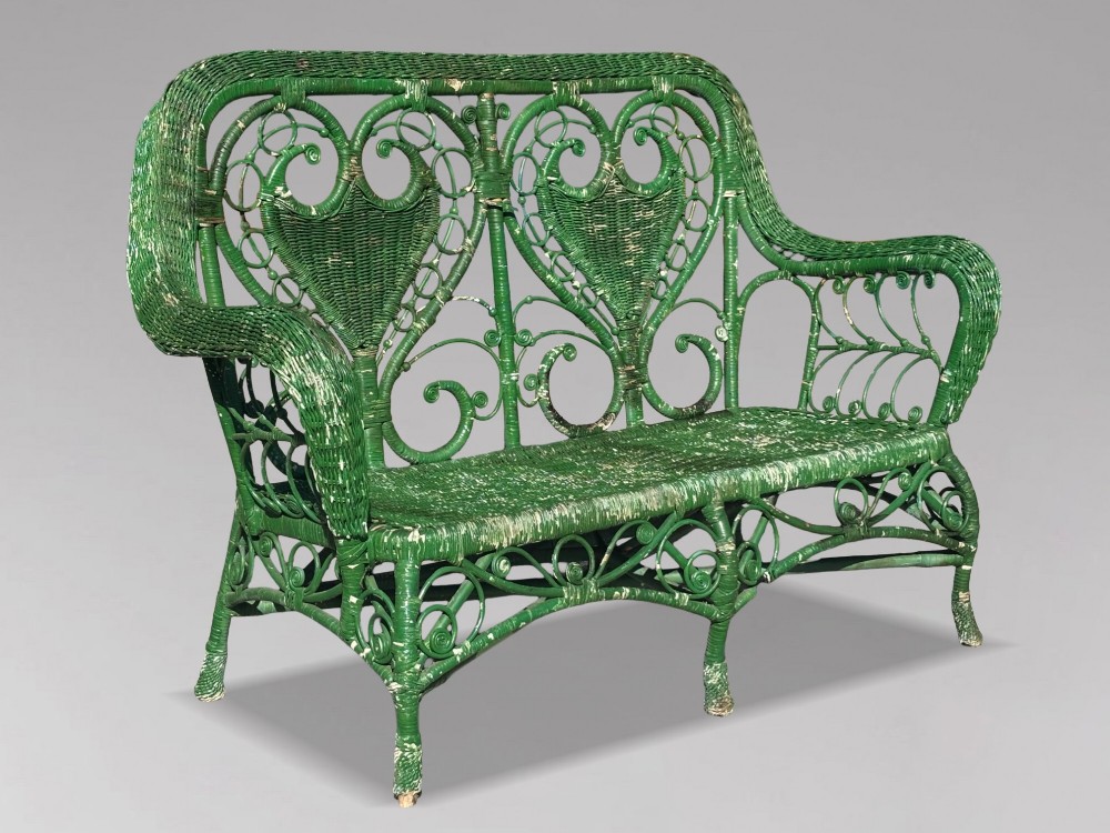 A French green painted wicker bench featuring two heart-shaped openwork back panels and curved armrests. View IX