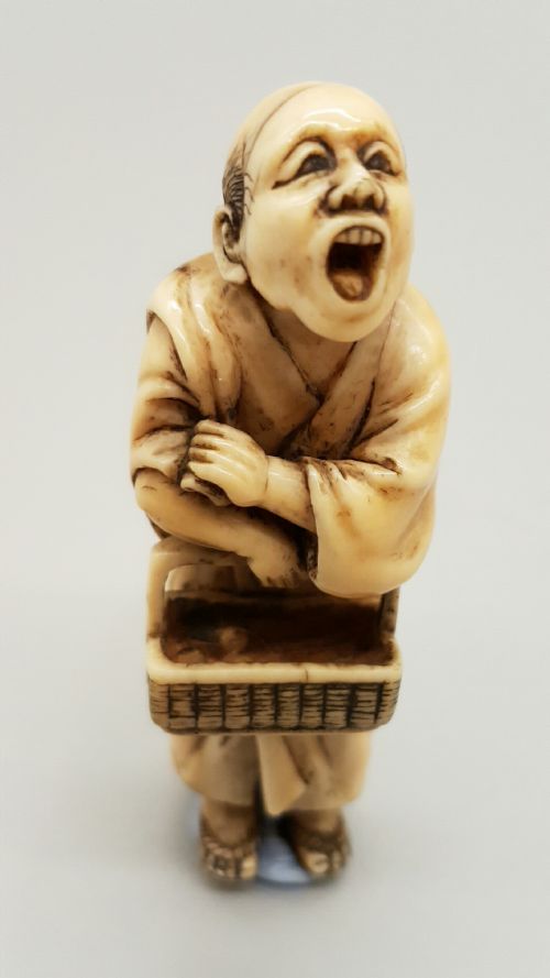rare japanese meiji ivory netsuke of a street vendor signed kaigyokusai masatsugu - CATEGORY: ANTIQUE MISCELLANEOUS - DATED 19TH CENTURY