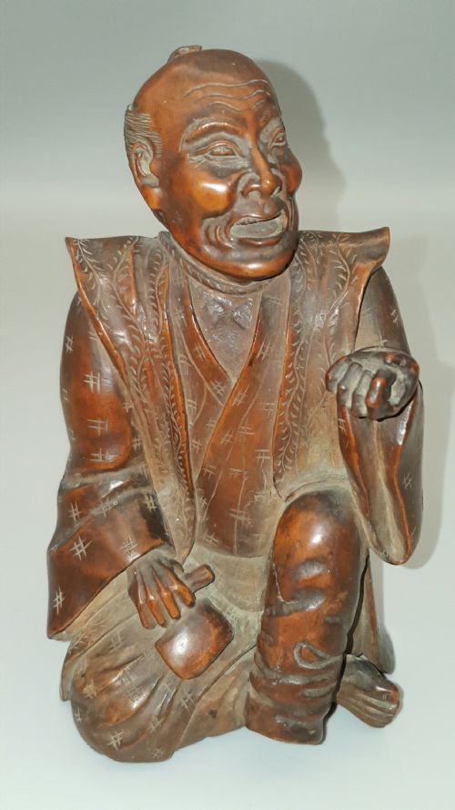 characterful japanese meiji 19thc huang yang wood okimono carving of seated onelegged man - CATEGORY: ANTIQUE SCULPTURES - DATED 19TH CENTURY