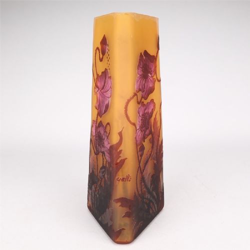 fig 1. A tall tapered triangular cameo glass vase decorated with acid-etched red poppy blossoms and foliage on a frosted amber yellow background.