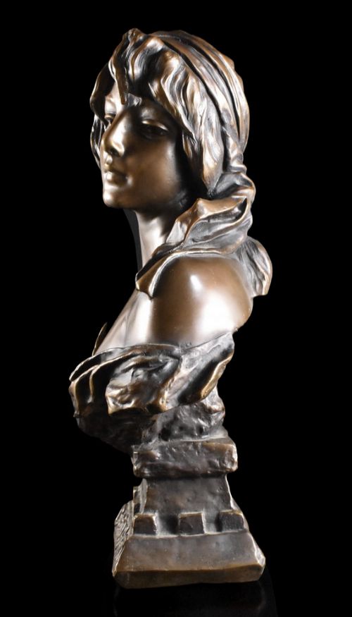 fig 1. An Art Nouveau patinated bronze bust of a woman with draped fabric and a headscarf, set on a pedestal inscribed Cendrillon.
