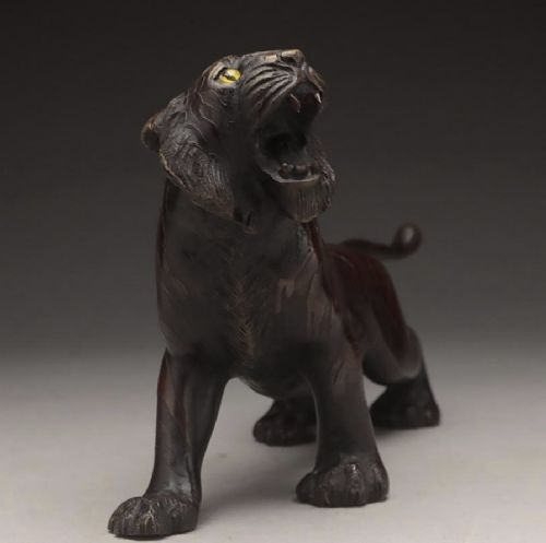 A dark patinated bronze sculpture depicting a snarling tiger in a low prowling stance with inset yellow crystal eyes. View IV