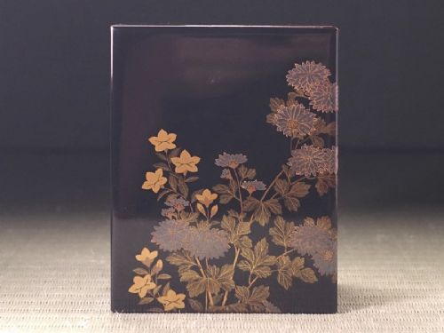 Rectangular black lacquer box decorated with gold and silver floral chrysanthemum motifs on the upper lid surface. View II