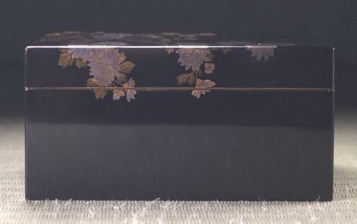 Rectangular black lacquer box decorated with gold and silver floral chrysanthemum motifs on the upper lid surface. View VI