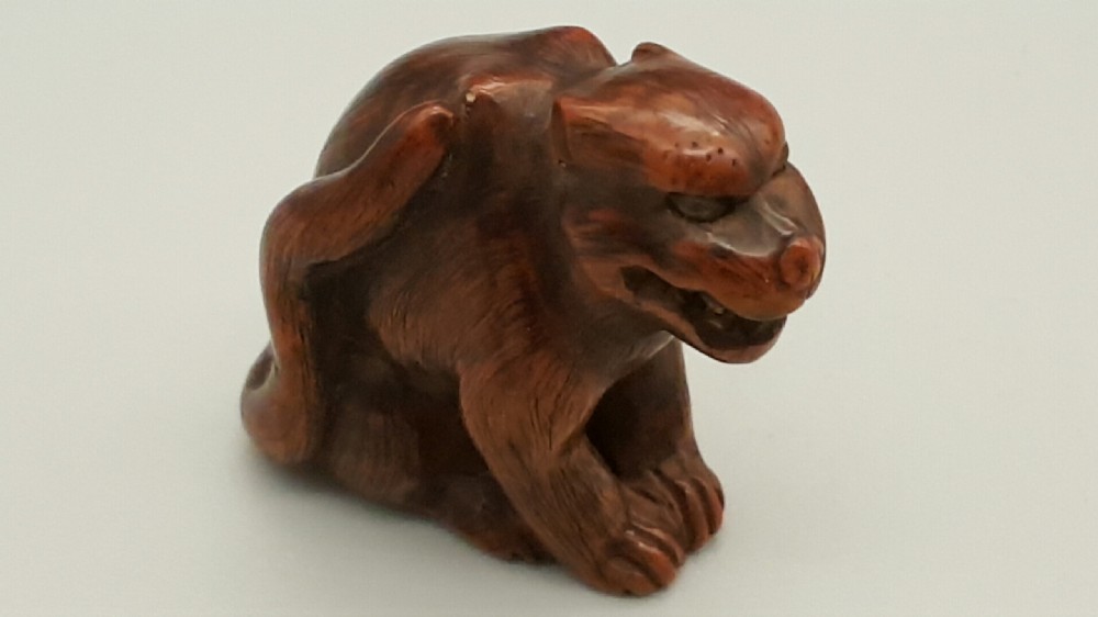 Japanese Edo (19thC) Boxwood Netsuke of a Tiger with Inlaid Eyes