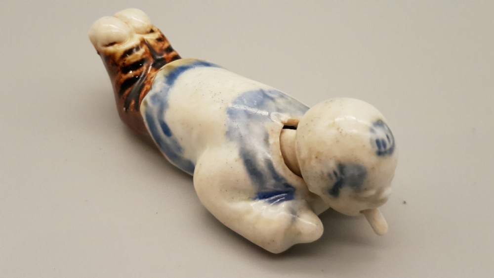 Japanese Meiji Hirado Porcelain Netsuke of a child with Moving Head & Tongue