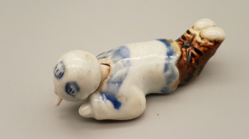 Japanese Meiji Hirado Porcelain Netsuke of a child with Moving Head & Tongue View II