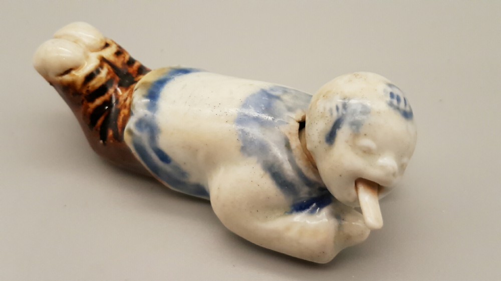 Japanese Meiji Hirado Porcelain Netsuke of a child with Moving Head & Tongue View III