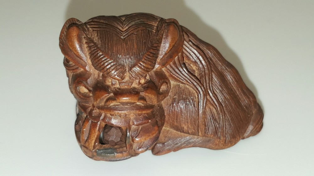 Japanese Meiji (19thC) Boxwood Netsuke of Shishi Guarding a Sacred Ball, signed Masayoshi
