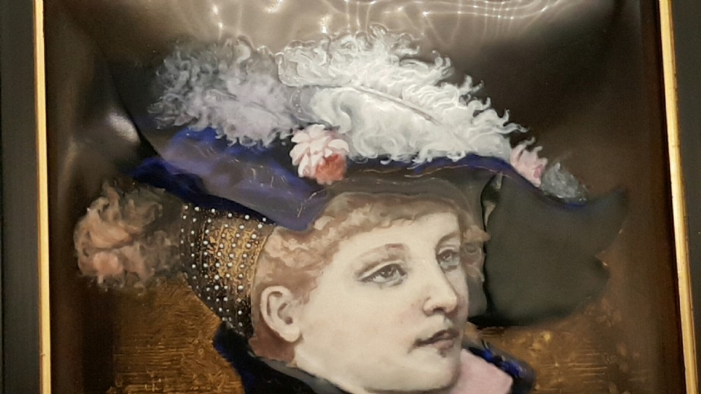 A 19th-century French Limoges enamel porcelain plaque featuring a portrait of a woman in Renaissance clothing, presented within a dark moulded frame. View IV