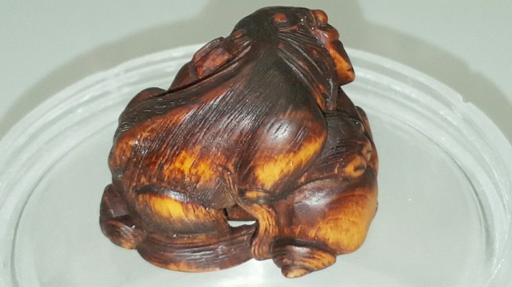 Japanese Edo (mid 19thC) Boxwood Netsuke of a Shishi Guarding a Sacred Ball, signed Masayoshi View II