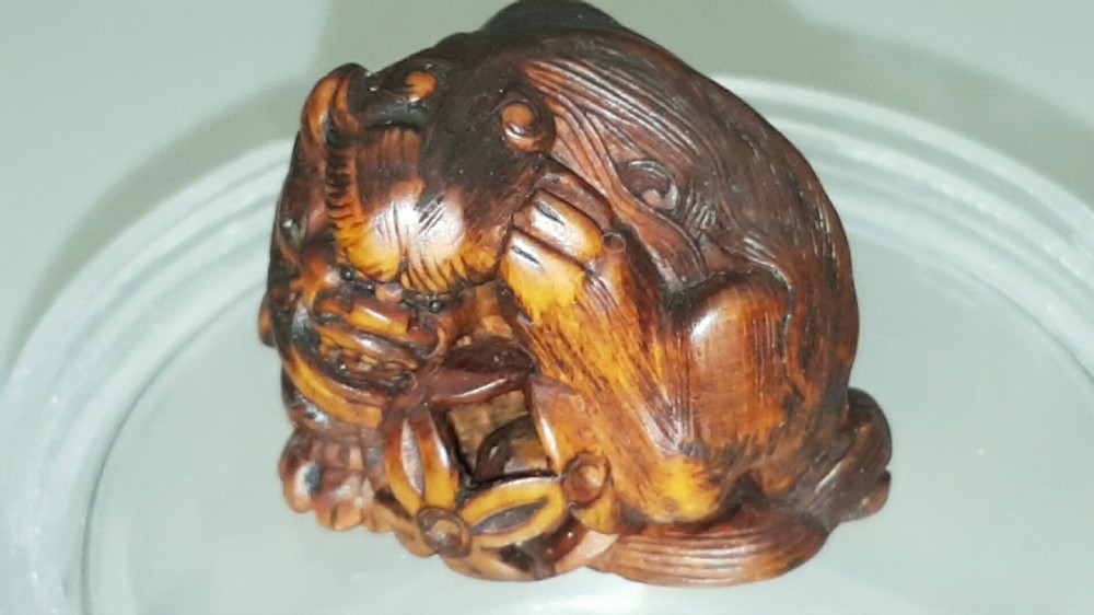 Japanese Edo (mid 19thC) Boxwood Netsuke of a Shishi Guarding a Sacred Ball, signed Masayoshi View III