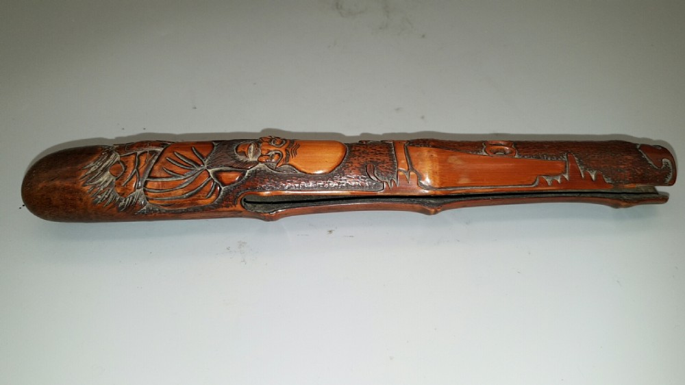 Japanese Meiji (19thC) Intricately Carved Wooden Pipecase (Kiseruzutsu) of Otoshi-Zutsu Form Depicting Fukurokuju View VII