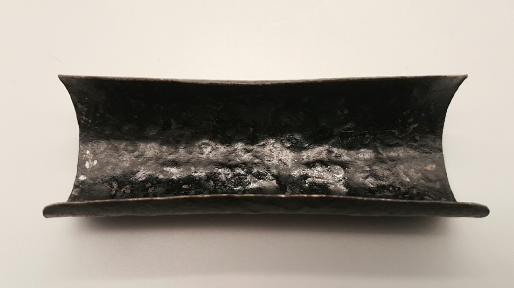 A cylindrical dark iron tea scoop featuring intricate silver and gold floral inlays across the surface. View IV