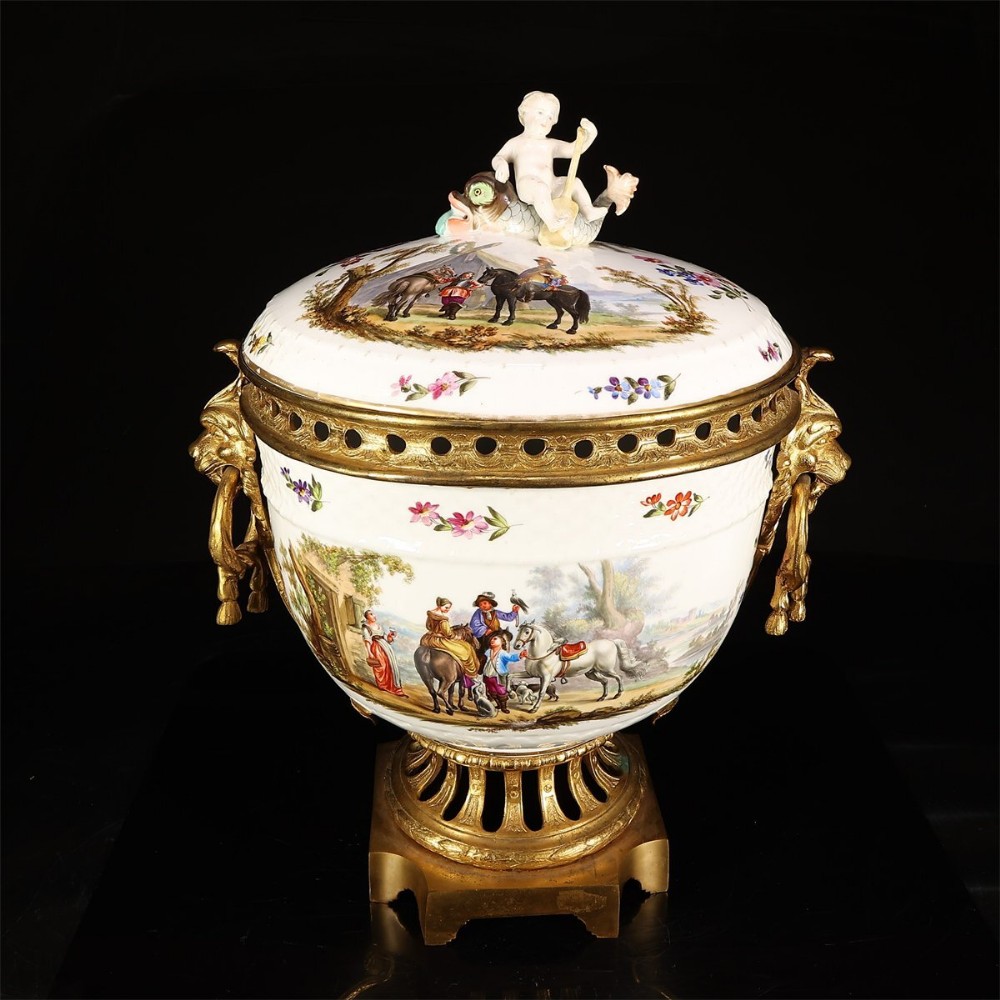 A 19th-century French porcelain potpourri urn with hand-painted equestrian scenes, gilt bronze lion-head handles, and a cherub lid finial.
