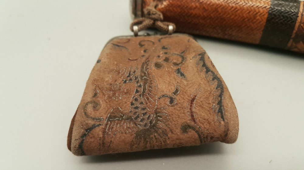 A Japanese woven bamboo pipe case with dark geometric weave bands paired with an attached pattern brocade purse. View VI