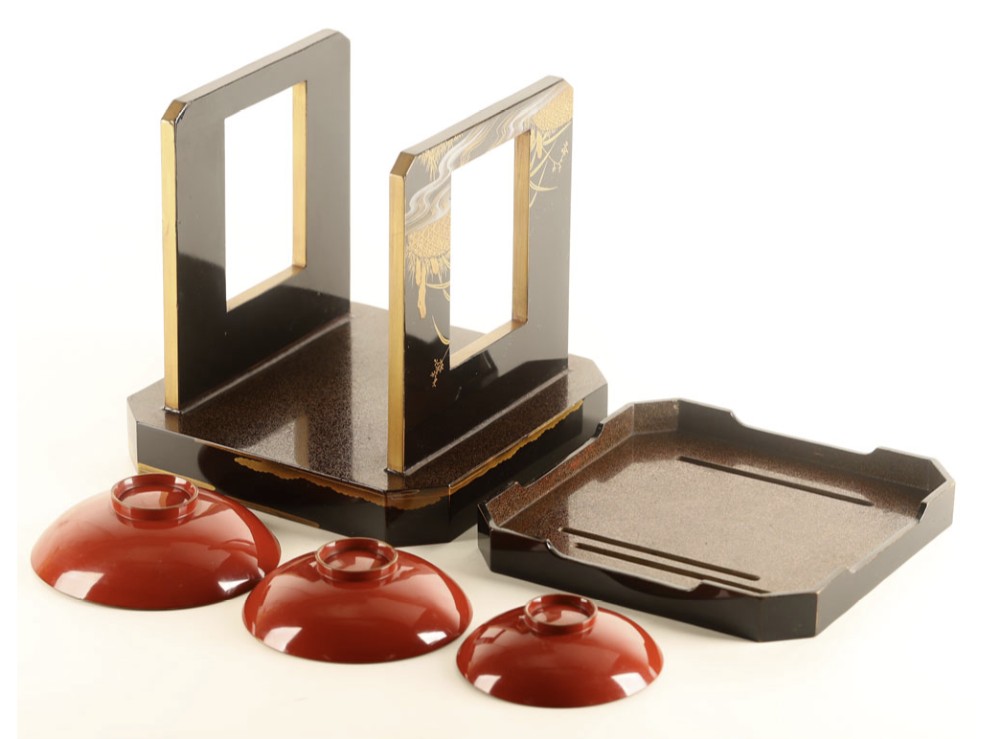 A Japanese black and gold lacquerware sake table featuring a raised stand, removable matching tray, and three red lacquer sakazuki cups adorned with painted gold motifs. View VIII